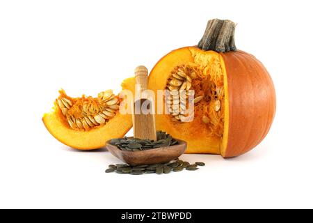 Pumpkin seeds or pepitas in wooden scoop and fresh pumpkin with seeds isolated on white background Stock Photo