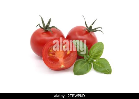 Cherry tomatoes with basil leaves isolated on white background Stock Photo