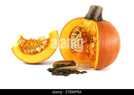 Pumpkin seeds or pepitas in wooden scoop and fresh pumpkin with seeds isolated on white background Stock Photo