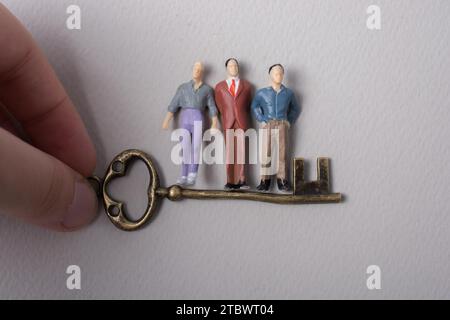 Tiny figurine of man miniature and retro key Stock Photo