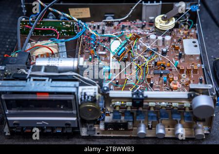 Schwerin, Germany. 28th Nov, 2023. A circuit board with electronic components in a music system from the GDR company RFT is repaired in a small workshop for old radios, record players and hi-fi systems. Small electrical appliances from East and West have been restored to working order here for around 34 years. Regular customers with a soft spot for GDR radio technology in particular hand in their devices to the trained radio and television technician. A lack of spare parts and declining interest among younger customers mean that the days of this unique work Credit: dpa/Ģ����ý Live News Stock Photo