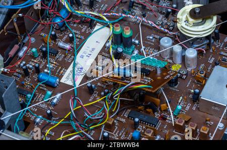 Schwerin, Germany. 28th Nov, 2023. A circuit board with electronic components in a music system from the GDR company RFT is repaired in a small workshop for old radios, record players and hi-fi systems. Small electrical appliances from East and West have been restored to working order here for around 34 years. Regular customers with a soft spot for GDR radio technology in particular hand in their devices to the trained radio and television technician. A lack of spare parts and declining interest among younger customers mean that the days of this unique work Credit: dpa/Ģ����ý Live News Stock Photo