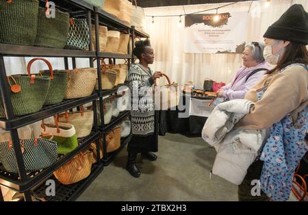 Vancouver, Canada. 8th Dec, 2023. A vendor displays her handmade bag during the Make It show in Vancouver, British Columbia, Canada, Dec. 8, 2023. The trade event dedicated to handmade items features exhibitors from across Canada, offering a diverse range of handmade goods. Credit: Liang Sen/Xinhua/Alamy Live News Stock Photo