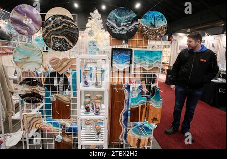 Vancouver, Canada. 8th Dec, 2023. A person visits the Make It show in Vancouver, British Columbia, Canada, Dec. 8, 2023. The trade event dedicated to handmade items features exhibitors from across Canada, offering a diverse range of handmade goods. Credit: Liang Sen/Xinhua/Alamy Live News Stock Photo