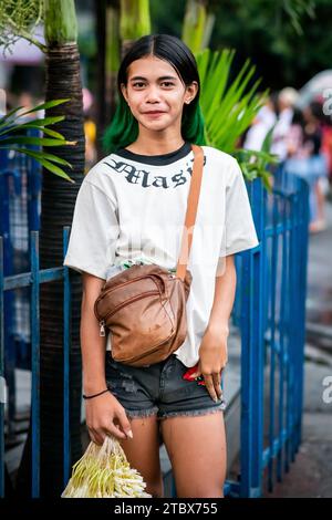 A beautiful young Filipino girl sells flower garlands outside the St. Nino Tondo Cathedral, Manila The Philippines. Stock Photo