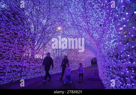Vancouver, Canada. 8th Dec, 2023. Visitors walk inside a light tunnel at the PNE Winter Fair at the Pacific National Exhibition in Vancouver, British Columbia, Canada, Dec. 8, 2023. Credit: Liang Sen/Xinhua/Alamy Live News Stock Photo