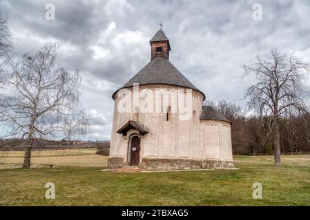 Saint Nicholas and Virgin Mary rotunda, Selo, Slovenia. Oldest rotunda in Slovenia - build in 13th century. Building of church standing near dirt road Stock Photo