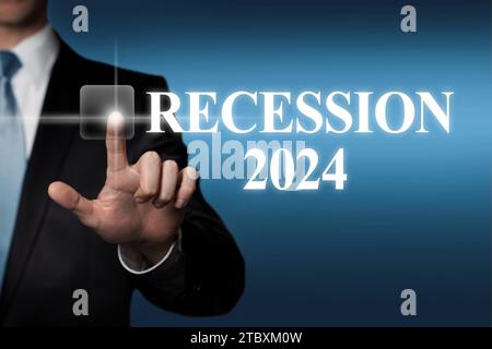 Recession 2024 - businessman pressing virtual touchscreen button Stock Photo