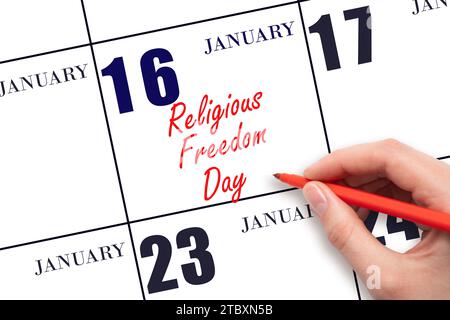 January 16. Hand writing text Religious Freedom Day on calendar date. Save the date. Holiday.  Day of the year concept. Stock Photo