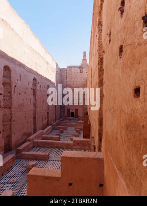 Courtyard with high earthen walls with tiled floors in Badi Palace as birds stick heads out. Marrakesh aka Marrakech, Morocco, December 09, 2023 Stock Photo