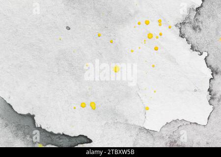 Macro close-up of hand painted gray watercolor background with watercolour stains and yellow drops. Textured paper background with copy space. Stock Photo