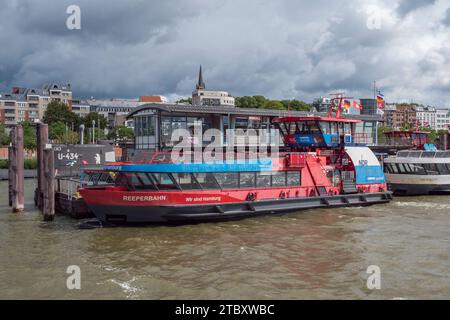 Red harbour ferry boat moored viewed from the 62 HADAG ferry in Hamburg, Germany. Stock Photo