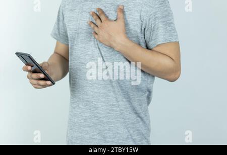 Asian man sending text message on smart phone on white Background Stock Photo
