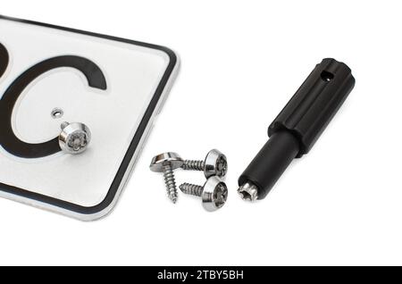 The license plate frame is white with a black number. The screws are secret. Special screwdriver. Isolated white background Stock Photo