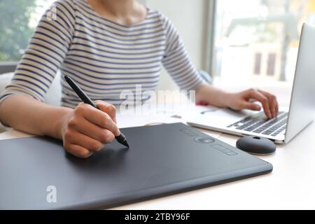 Woman who creates NFT works using tablet Stock Photo