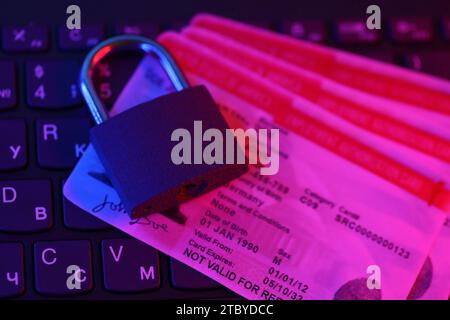 US Employment authorization card with small padlock on computer keyboard close up Stock Photo