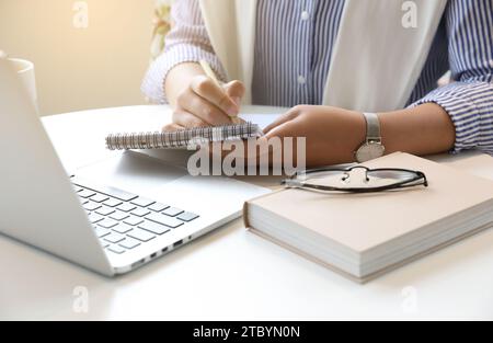 A woman who works or creates alone in a cafe Stock Photo