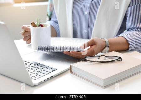 A woman who works or creates alone in a cafe Stock Photo