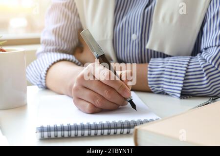 A woman who works or creates alone in a cafe Stock Photo