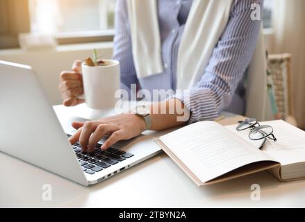 A woman who works or creates alone in a cafe Stock Photo