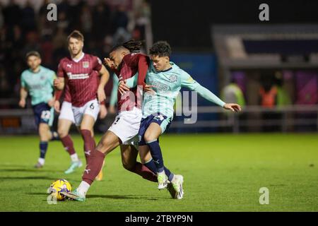 Northampton, UK. 9th Dec 2023. Northampton Town's Akinwale Odimayo is challenged by Fleetwood Town's Phoenix Patterson during the second half of the Sky Bet League 1 match between Northampton Town and Fleetwood Town at the PTS Academy Stadium, Northampton on Saturday 9th December 2023. (Photo: John Cripps | MI News) Credit: MI News & Sport /Alamy Live News Stock Photo