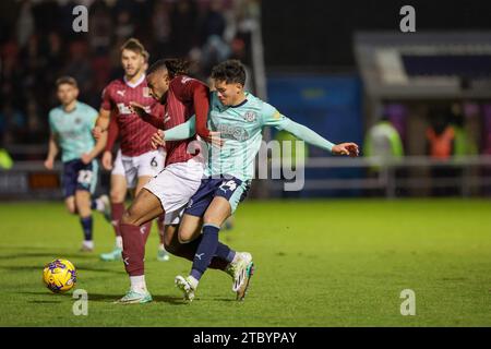 Northampton, UK. 9th Dec 2023. Northampton Town's Akinwale Odimayo is challenged by Fleetwood Town's Phoenix Patterson during the second half of the Sky Bet League 1 match between Northampton Town and Fleetwood Town at the PTS Academy Stadium, Northampton on Saturday 9th December 2023. (Photo: John Cripps | MI News) Credit: MI News & Sport /Alamy Live News Stock Photo