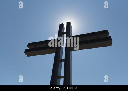Iron catholic cross against blue sky. Rossoschka German War Cemetery. Volgograd. (Stalingrad). Russia. Stock Photo
