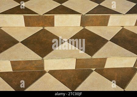 Concrete stairs are decorated with square, rectangular and triangular ceramic tiles Stock Photo