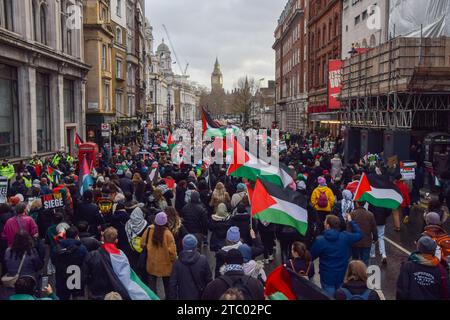 London, UK. 09th Dec, 2023. Protesters hold Palestinian flags during the demonstration in Whitehall. Thousands of people marched in solidarity with Palestine in Central London, calling for a ceasefire as the Israel-Hamas war continues. Credit: SOPA Images Limited/Alamy Live News Stock Photo