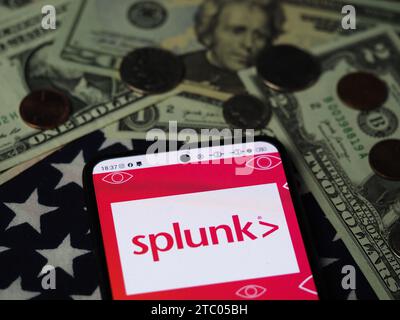 Bavaria, Germany - December 9, 2023: In this photo illustration,  Splunk Inc. part of Cisco logo seen displayed on a smartphone with United States Dol Stock Photo