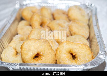 Delectable Fresh Hot Donuts, Glistening with Sugar on a Disposable Silver Foil Baking Pan. Sfenj, Popular Moroccan Doughnuts, Are Enjoyed in Israel During Both Hanukkah and Mimouna Celebrations. Stock Photo