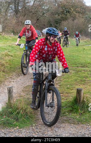 9th December 2023. Competitors riding their mountain bikes in the Dirty Santa MTB trail cycling event in the Surrey Hills, England, UK. Many of the cyclists were in Christmas themed fancy dress costumes, and were getting very muddy on the off-road route through the Surrey Hills Area of Outstanding Natural Beauty. Stock Photo