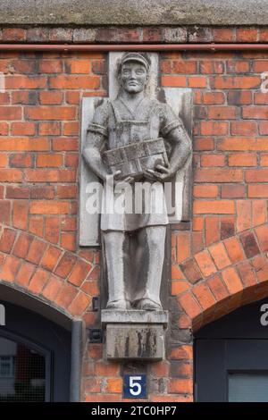 Stonework detail on the exterior of one re brick warehouse in the Speicherstadt district of Hamburg, Germany. Stock Photo