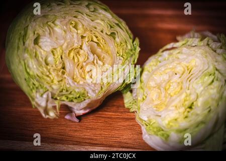 I lettuce cut in half on wooden chopping board Stock Photo