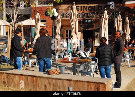 Friends hang out at the First and Last Chance Saloon, a historic tavern in Jack London Square in Oakland, California Stock Photo