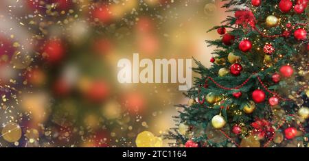 Christmas tree decorated with red and golden festive balls against blurred background, bokeh effect. Banner design with space for text Stock Photo
