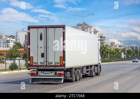 Truck transportation on the road on a highway in the city on a nice sky clear summer day Stock Photo