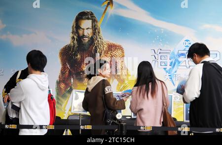 Shanghai, China. 09th Dec, 2023. Fans are standing in front of a poster of the film 'Aquaman and The Lost Kingdom' at a cinema in Shanghai, China, on December 9, 2023. (Photo by Costfoto/NurPhoto) Credit: NurPhoto SRL/Alamy Live News Stock Photo