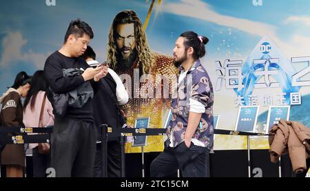 Shanghai, China. 09th Dec, 2023. Fans are standing in front of a poster of the film 'Aquaman and The Lost Kingdom' at a cinema in Shanghai, China, on December 9, 2023. (Photo by Costfoto/NurPhoto) Credit: NurPhoto SRL/Alamy Live News Stock Photo