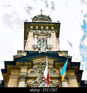 A fragment of the town hall, built in the eclectic style after the fire of 1894. The tower is decorated with a historical clock. Stock Photo