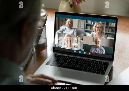 Aged man using laptop to talk with old friends online Stock Photo