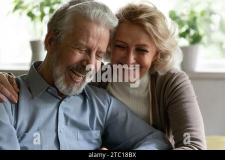 Happy retired family couple embracing spending time for pleasant conversation Stock Photo