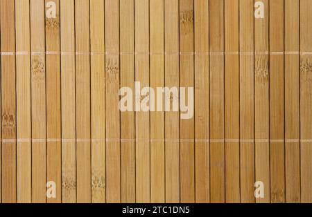 A wall made of pieces of bamboo wood. Stock Photo