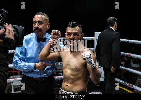 Long Beach, California, USA. 9th Dec, 2023. Mario Hernandez (11-4-1 white and black) has his hand raised after being declared the winner of his 6 round bantamweight bout with Adrian Alvarado (Credit Image: © Adam DelGiudice/ZUMA Press Wire) EDITORIAL USAGE ONLY! Not for Commercial USAGE! Credit: ZUMA Press, Inc./Alamy Live News Stock Photo