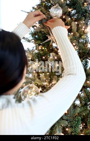 woman decorating the christmas tree Stock Photo