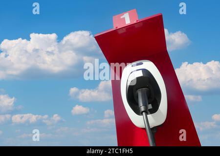 CHIANG MAI, THAILAND JUNE 17, 2023 : A closeup of a station for charging of electric cars at a parking lot in oil station. Stock Photo