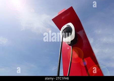 CHIANG MAI, THAILAND JUNE 17, 2023 : A closeup of a station for charging of electric cars at a parking lot in oil station. Stock Photo