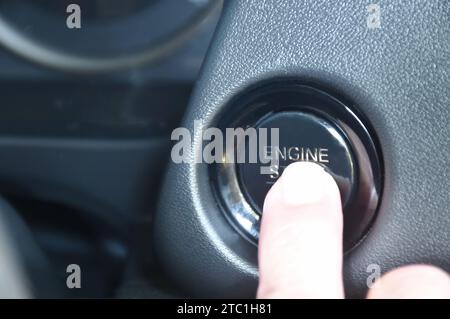 car engine start by finger pushing button in cockpit Stock Photo