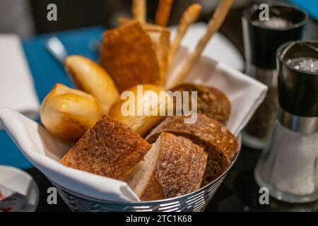 Different types of sliced bread in the basket, on the table in the restaurant Stock Photo