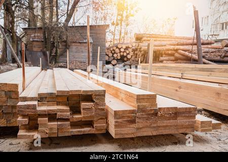 Planks and logs in a sawmill warehouse. Wood harvesting, Woodworking industry Stock Photo
